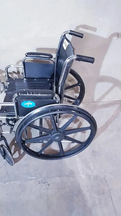 Black metal medline k1206n22e manual wheelchair for adult with padded seat and swing backrest shown from front angle