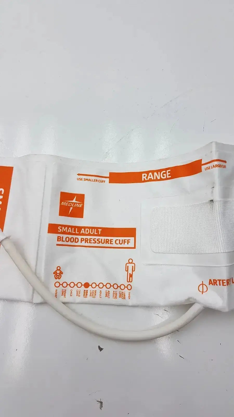 Medline small adult bp cuff in white and orange with elastic material and printed measurement guidelines range 20.5 to 28.5
