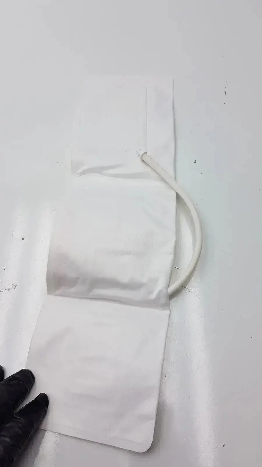 White plastic medical drainage bag with curved white tube for medline small adult bp cuff range 20.5 to 28.5