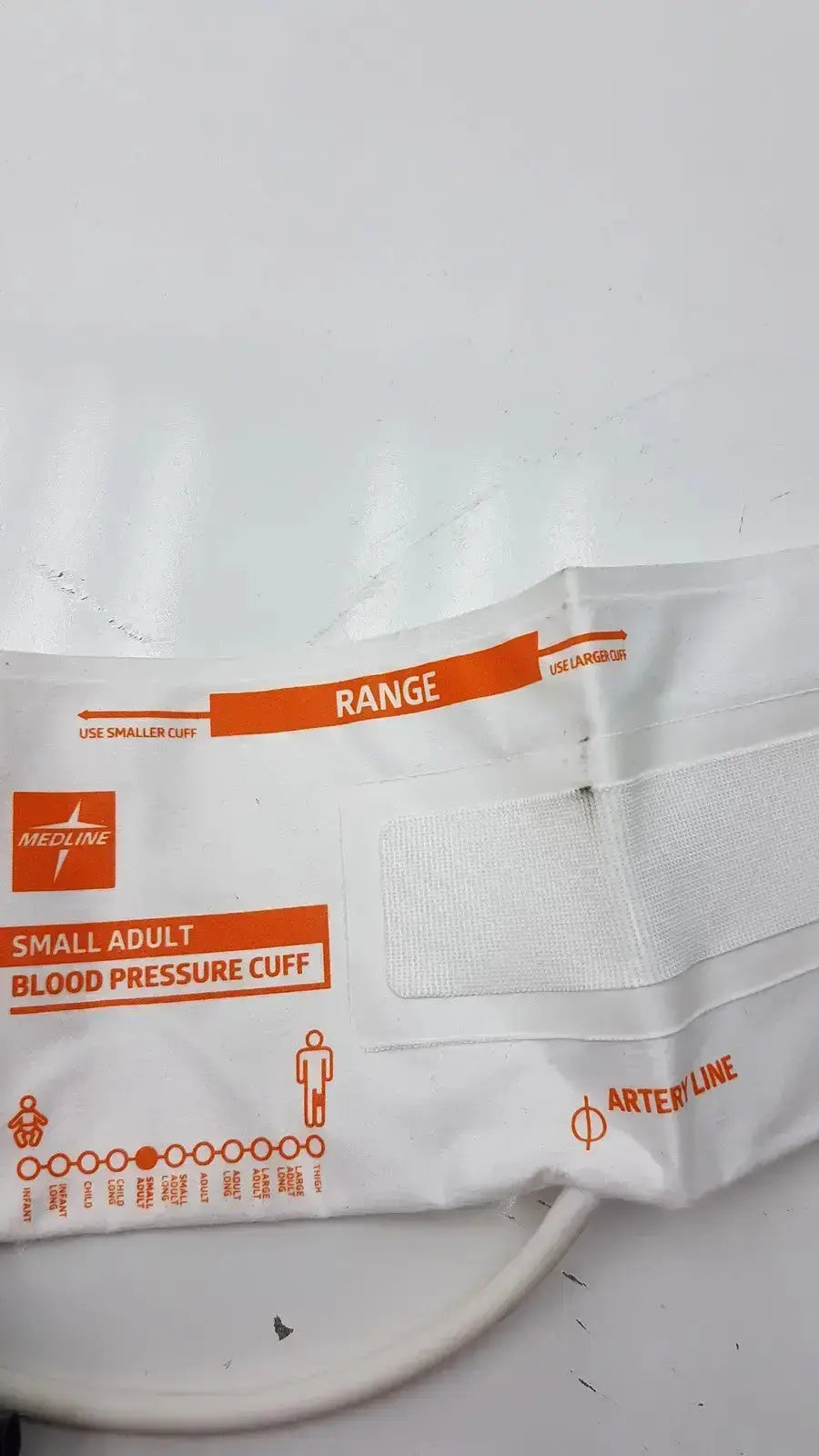 White medline small adult bp cuff with orange printed labels and elastic straps for arm circumference 20.5 to 28.5 cm