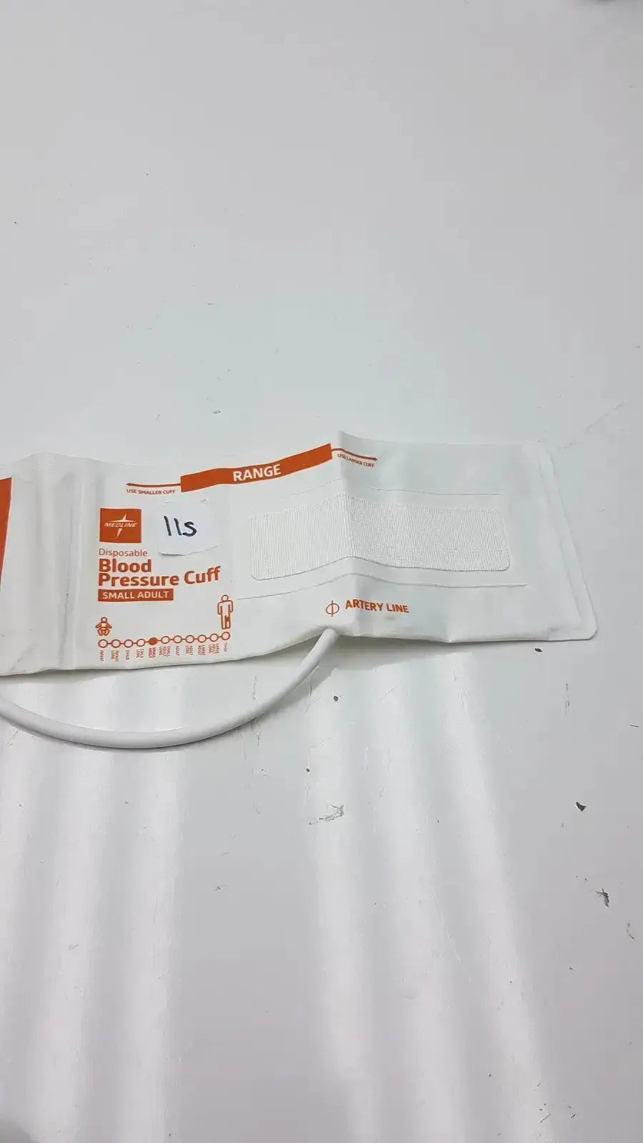 White disposable medline small adult pressure cuff with orange branding and white tubing for adult blood pressure use
