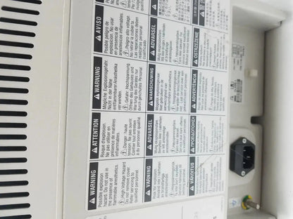 White plastic medrad stellant ct power supply showing black power plug and multilingual safety warning labels on back side