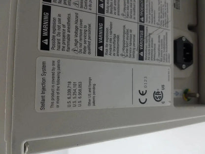 White plastic label with black text and regulatory markings on the back of medrad stellant ct power supply unit