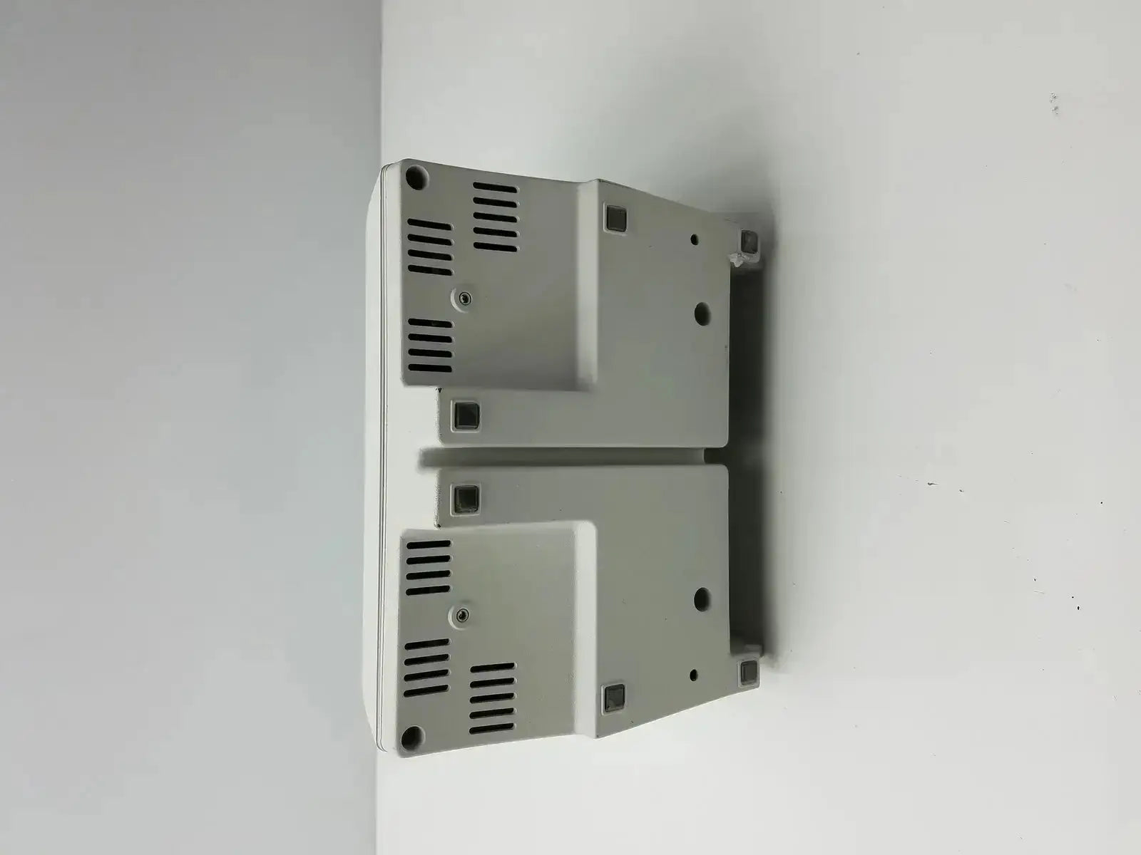 Two stacked light gray metallic industrial control panels with vented sides for medrad stellant ct power supply