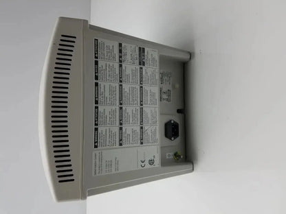 Gray plastic medrad stellant ct power supply with vented side panel and warning labels for medical use