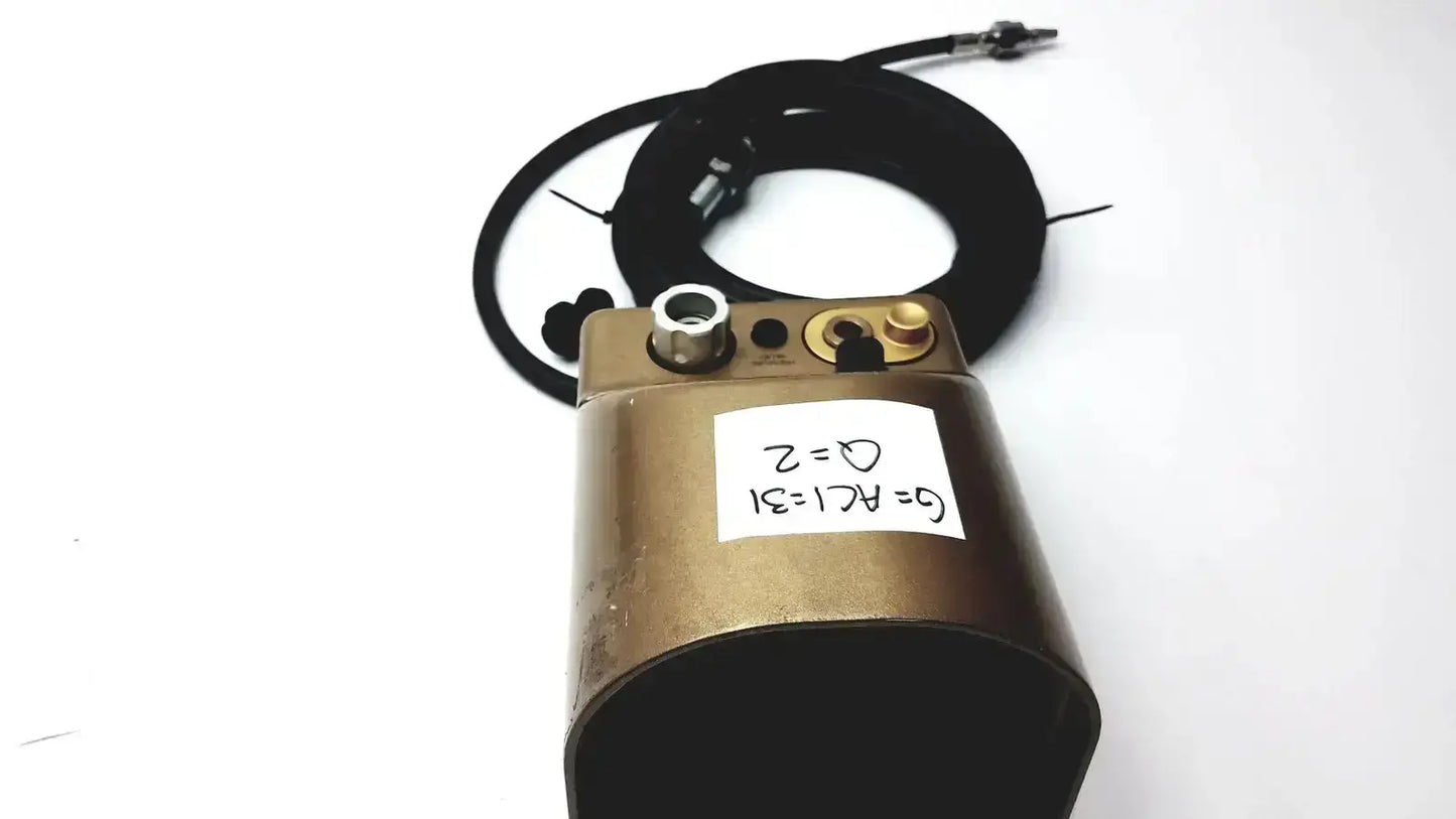 Bronze-colored midas rex legend gold pneumatic cylindrical device with black coiled cable and brass fittings medtronic c6774-12