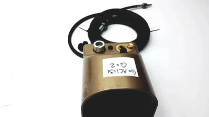 Bronze-colored midas rex legend gold pneumatic cylindrical device with black coiled cable and brass fittings medtronic c6774-12