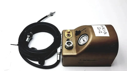 Bronze-colored metal midas rex legend gold pneumatic air compressor unit with black coiled hose and pressure gauge