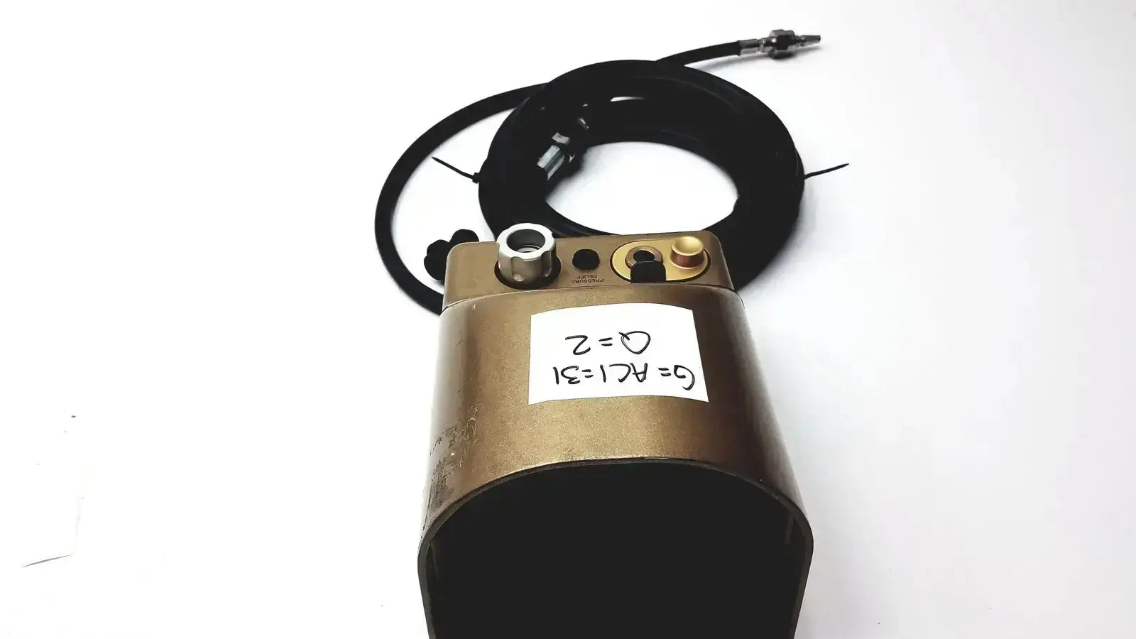 Bronze midas rex legend gold pneumatic device with metallic fittings and coiled black cable featuring handwritten label