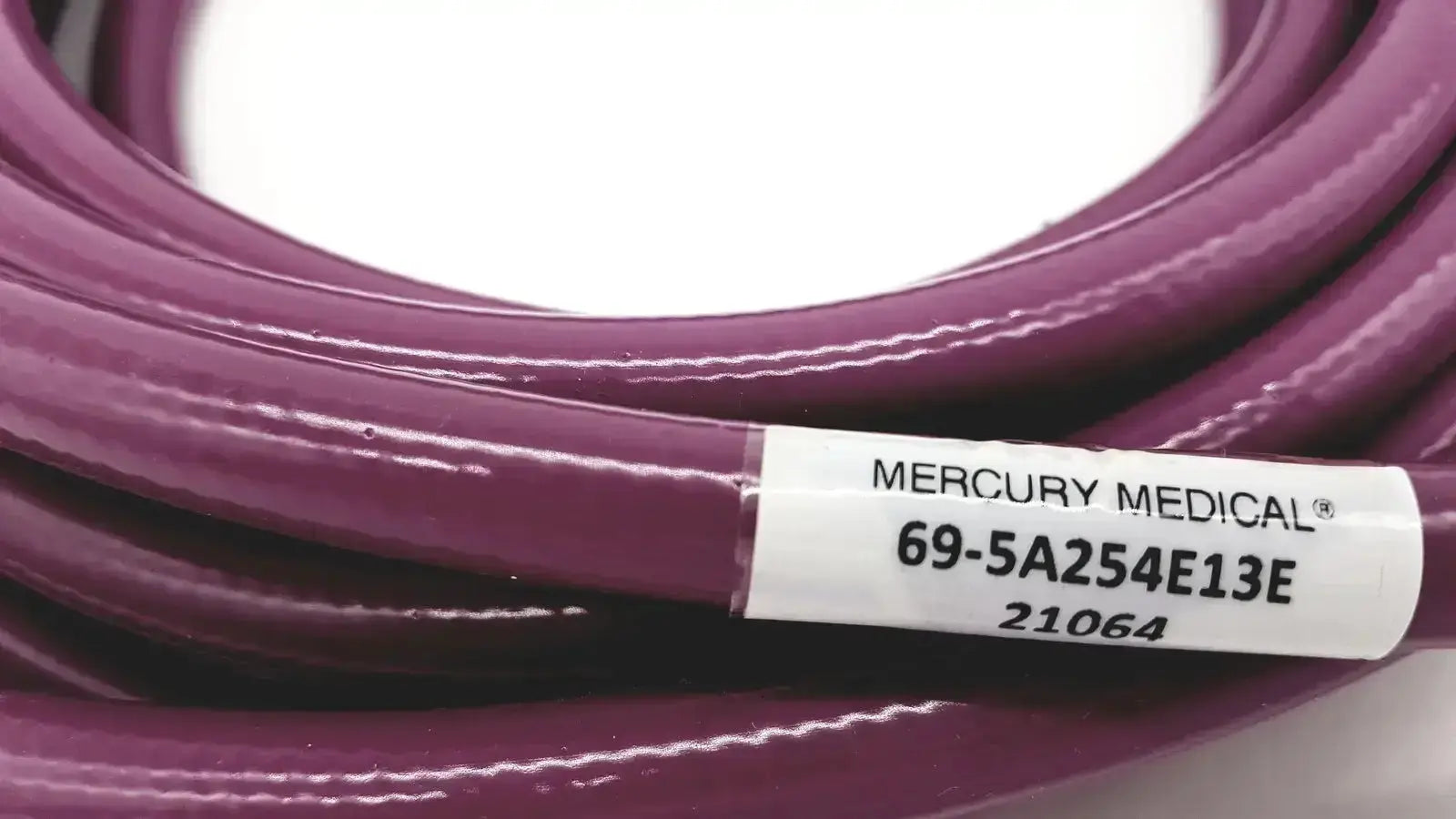 Purple coiled mercury medical conductive vacuum hose assembly 69-5a254e13e with white branded label visible