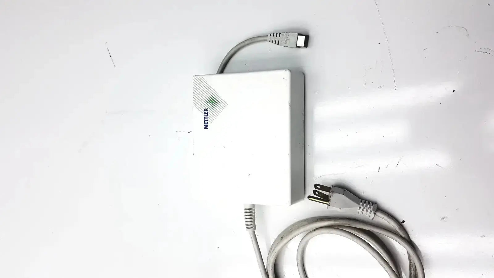 White rectangular mettler toledo power supply with gray cables for digital balance scale model me-210391