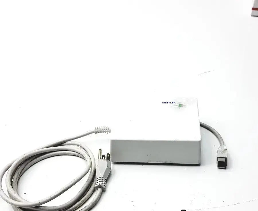 White rectangular Mettler ME-210391 power supply with coiled gray power cord for digital balance scale use