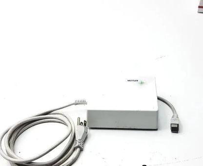 White rectangular Mettler ME-210391 power supply with coiled gray power cord for digital balance scale use