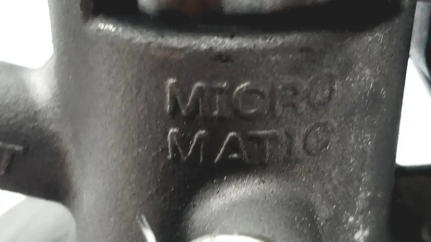 Dark gray metallic micro matic inlet keg coupler with raised micro matic engraving and 12 psi max pressure