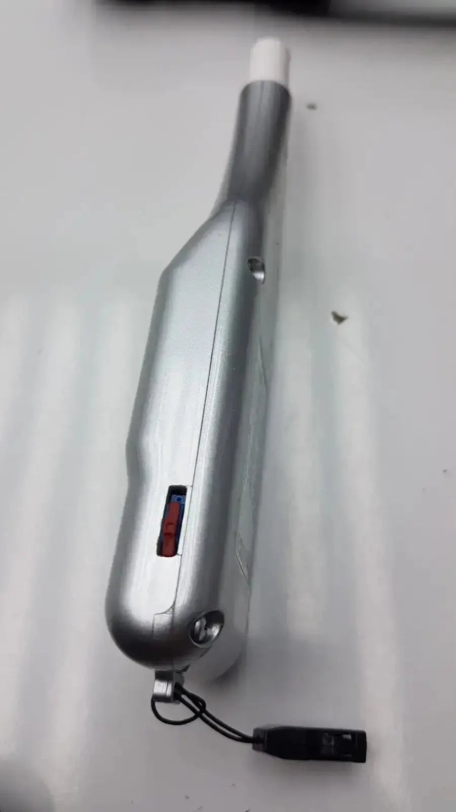 Silver metallic micro medical devices palmscan p2000 fastpach pachymeter with white cap and black lanyard attachment