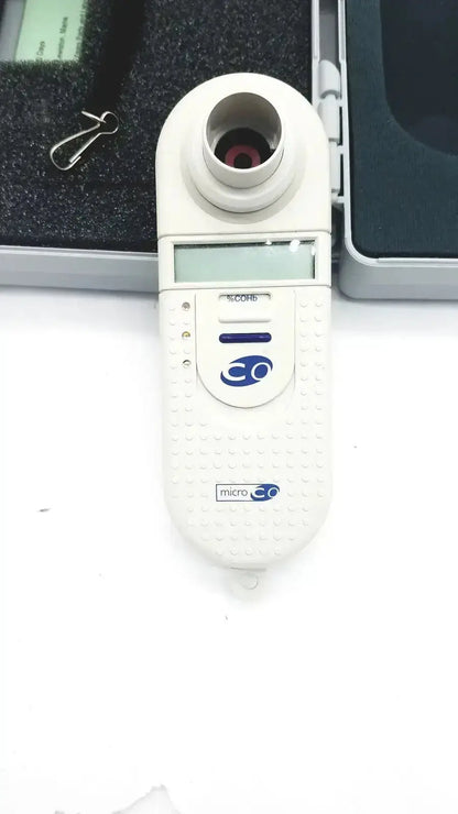 Micro Medical MicroCO white handheld carbon monoxide monitor with digital display blue logo and textured grip surface