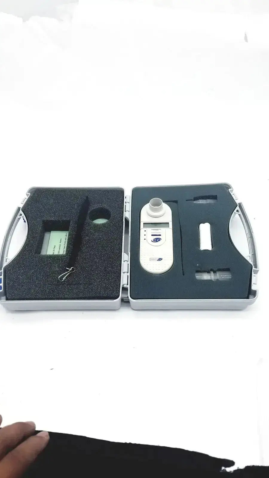White digital carbon monoxide monitor with small screen and usb port in black foam-lined case by micro medical