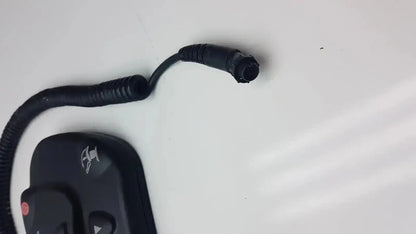 Black coiled cable with connector attached to black remote control for midmark 647 podiatry chair foot control