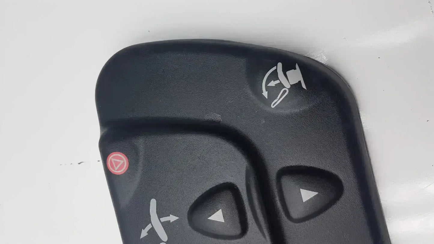Black plastic midmark 647 podiatry chair foot control with white directional and red circular buttons for chair foot control