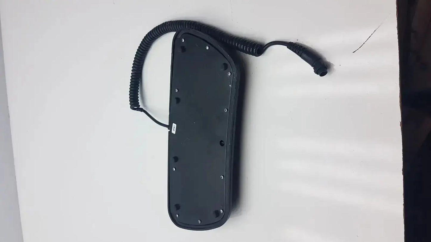 Black rectangular Midmark 647 podiatry chair foot control with coiled cable and multiple screw holes on back side