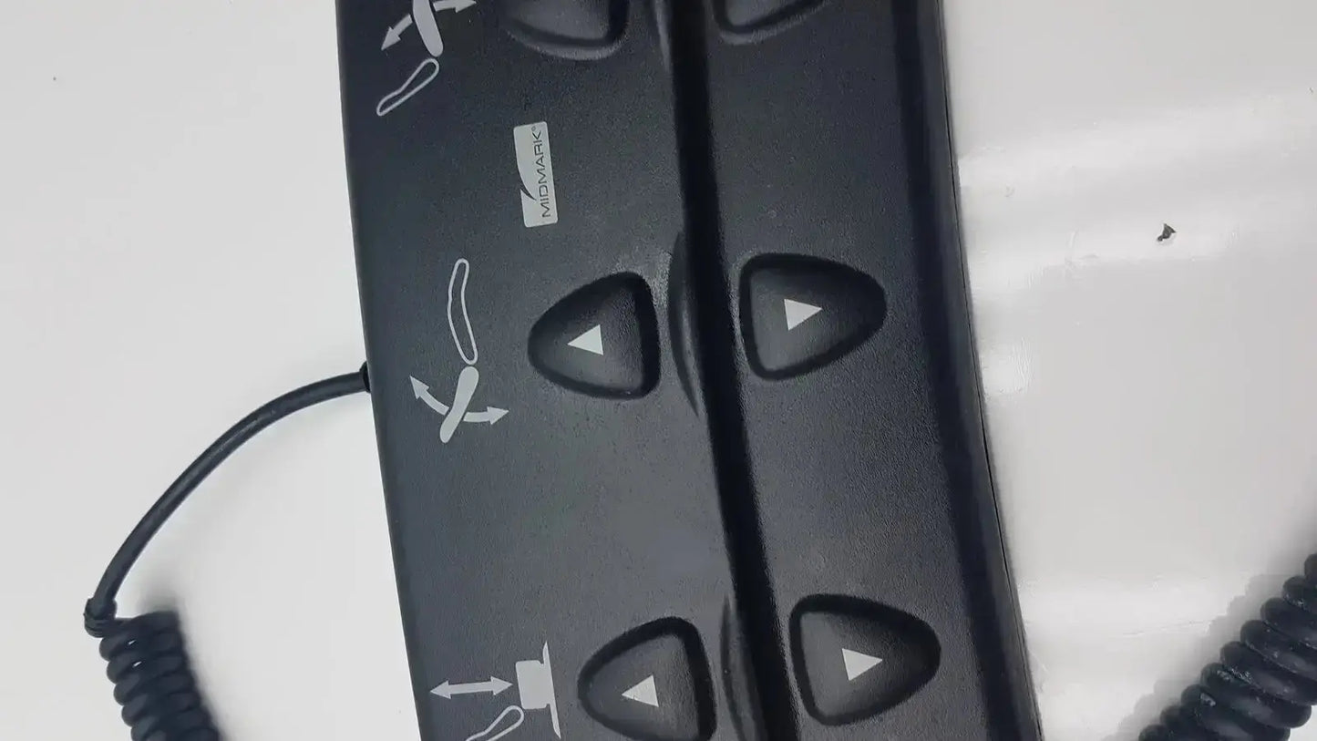 Black plastic podiatry chair foot control with triangular buttons and white directional icons for midmark 647 chair