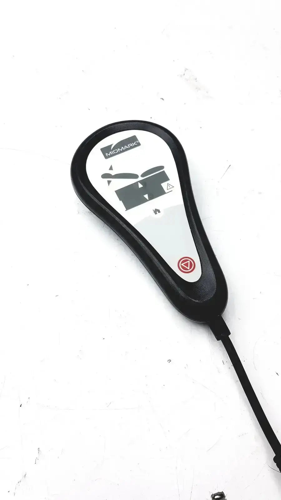 Black plastic Midmark exam table hand remote control with white label and red button for table hand operation
