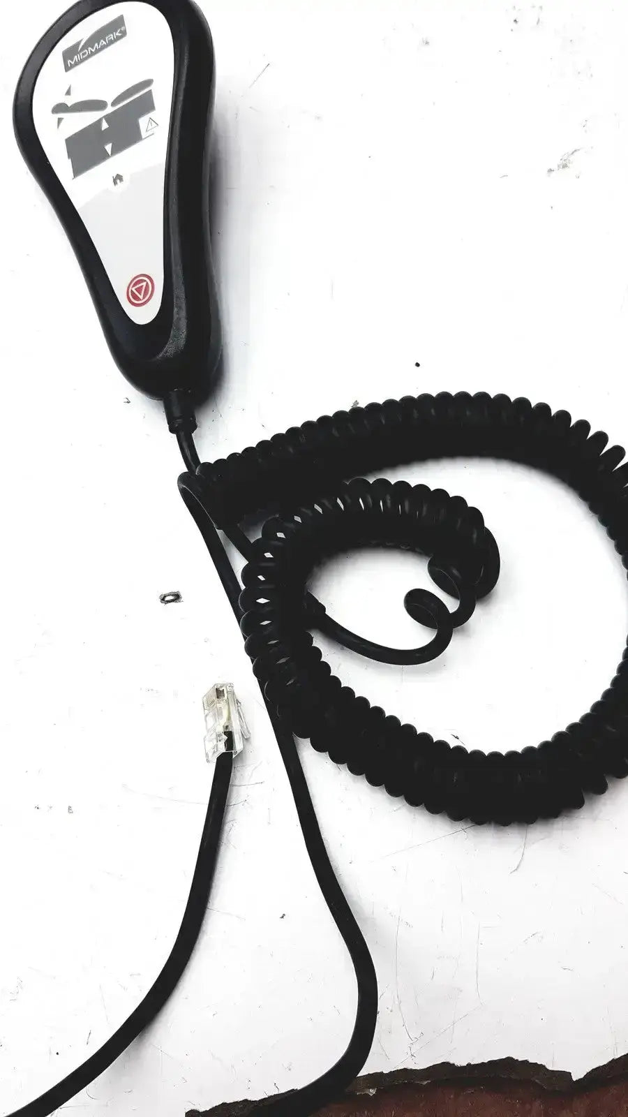 Black coiled telephone handset with white control panel and mosaic branding for midmark exam table hand remote control