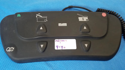 Black plastic midmark qe ipx1 wired medical equipment control panel with four triangular buttons for pot functions
