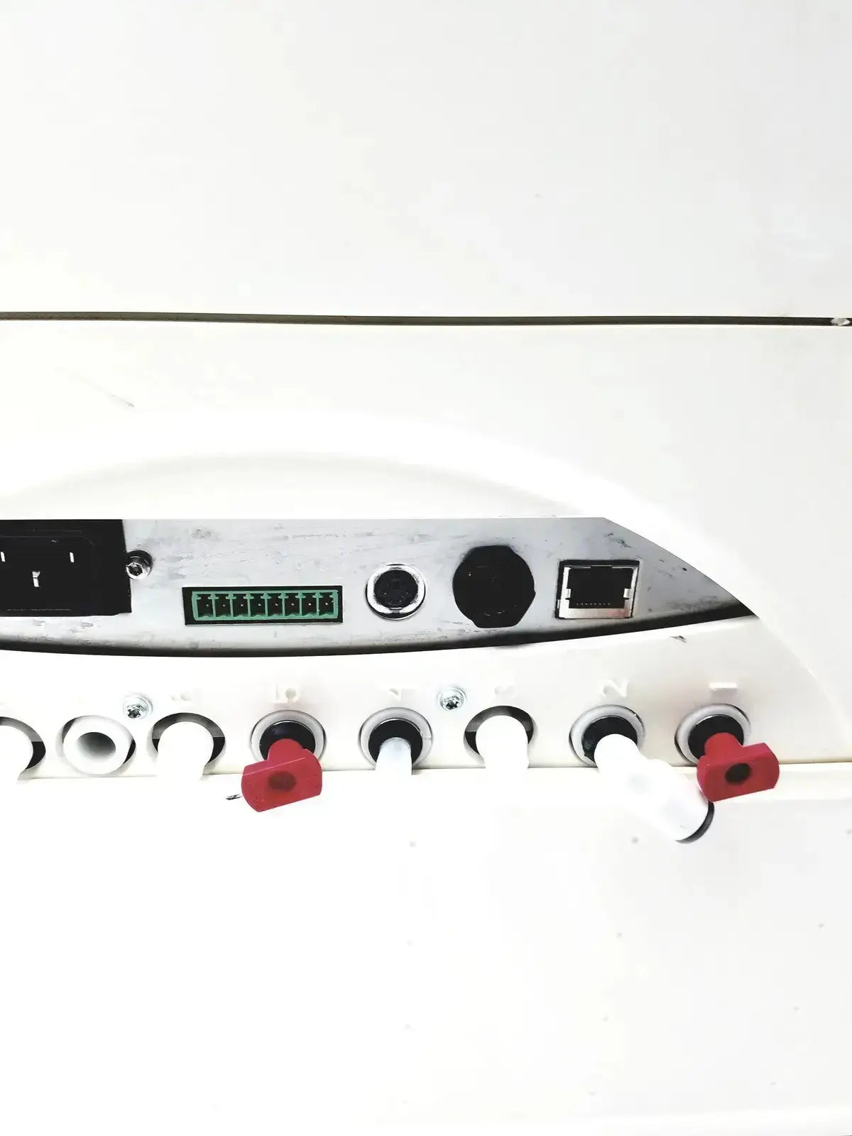 White millipore milli-q advantage a10 toc monitor with silver control panel and red heart-shaped caps on tubing connectors