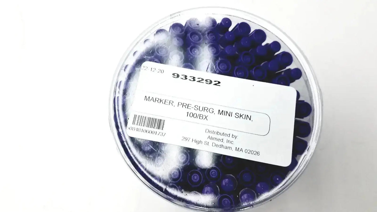 A clear plastic container with dark blue mini pre-surgery skin markers featuring scurb resistant ink