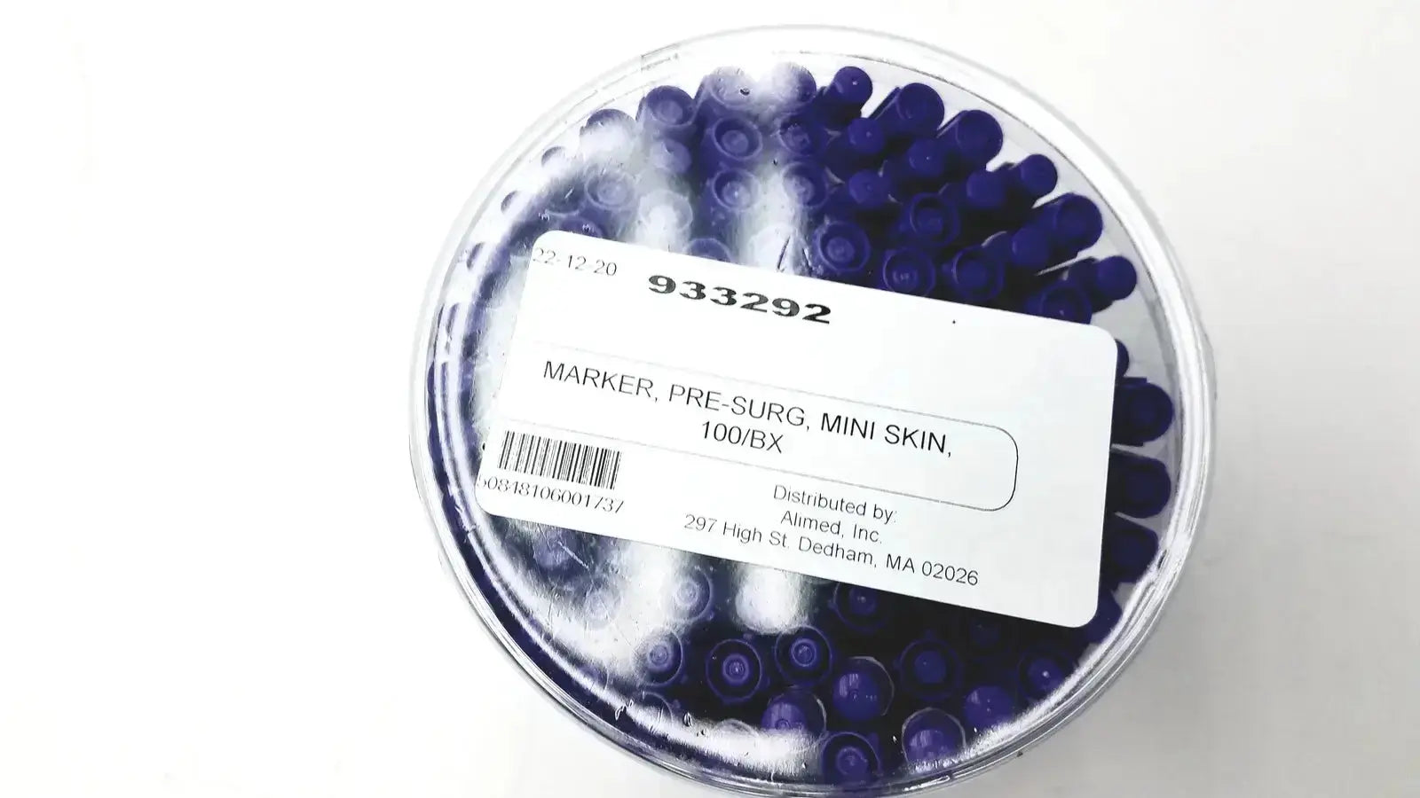 A clear plastic container with dark blue mini pre-surgery skin markers featuring scurb resistant ink