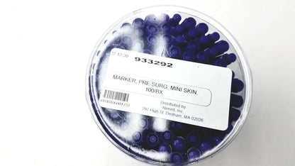 A clear plastic container with dark blue mini pre-surgery skin markers featuring scurb resistant ink