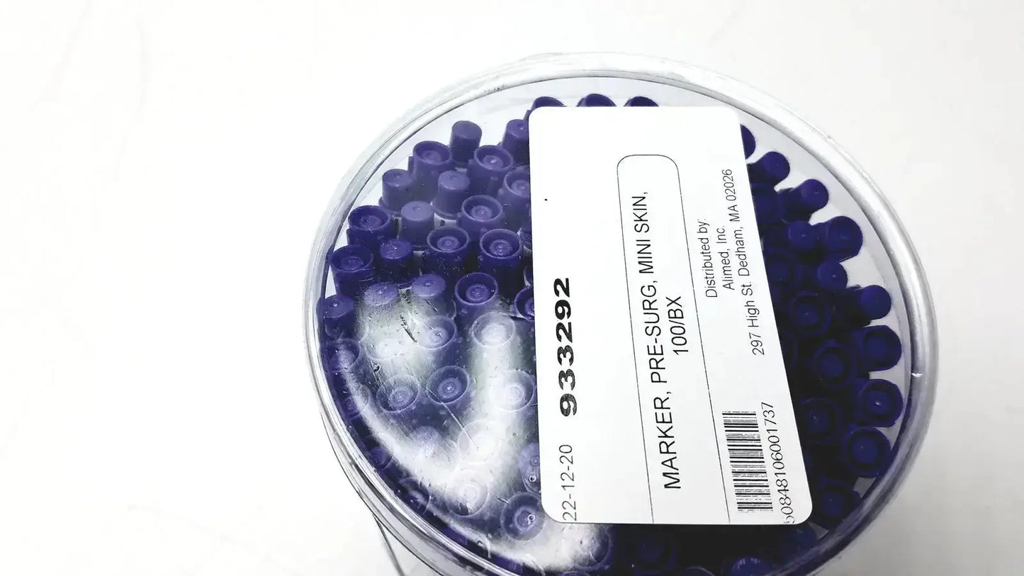 A clear plastic container filled with 100 dark blue mini pre-surgery skin markers with scurb resistant ink