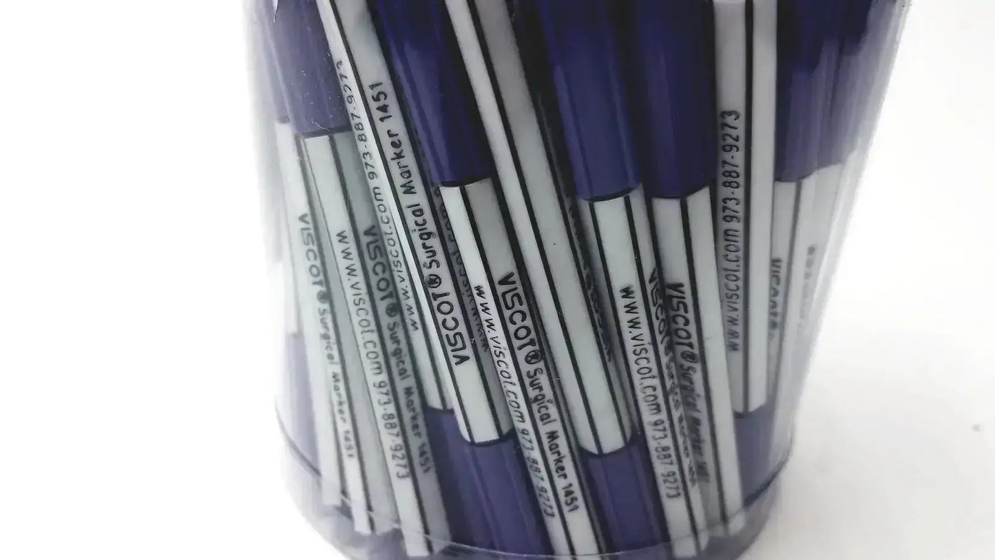 A clear plastic container filled with blue and white mini pre-surgery skin markers with scurb resistant ink