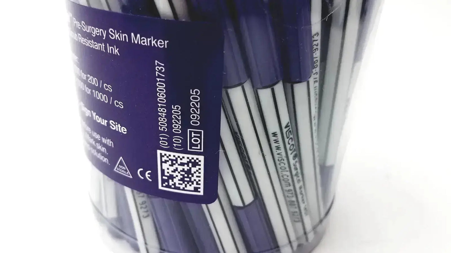 A clear plastic container holds blue and white mini pre-surgery skin markers with scurb resistant ink and black text labels