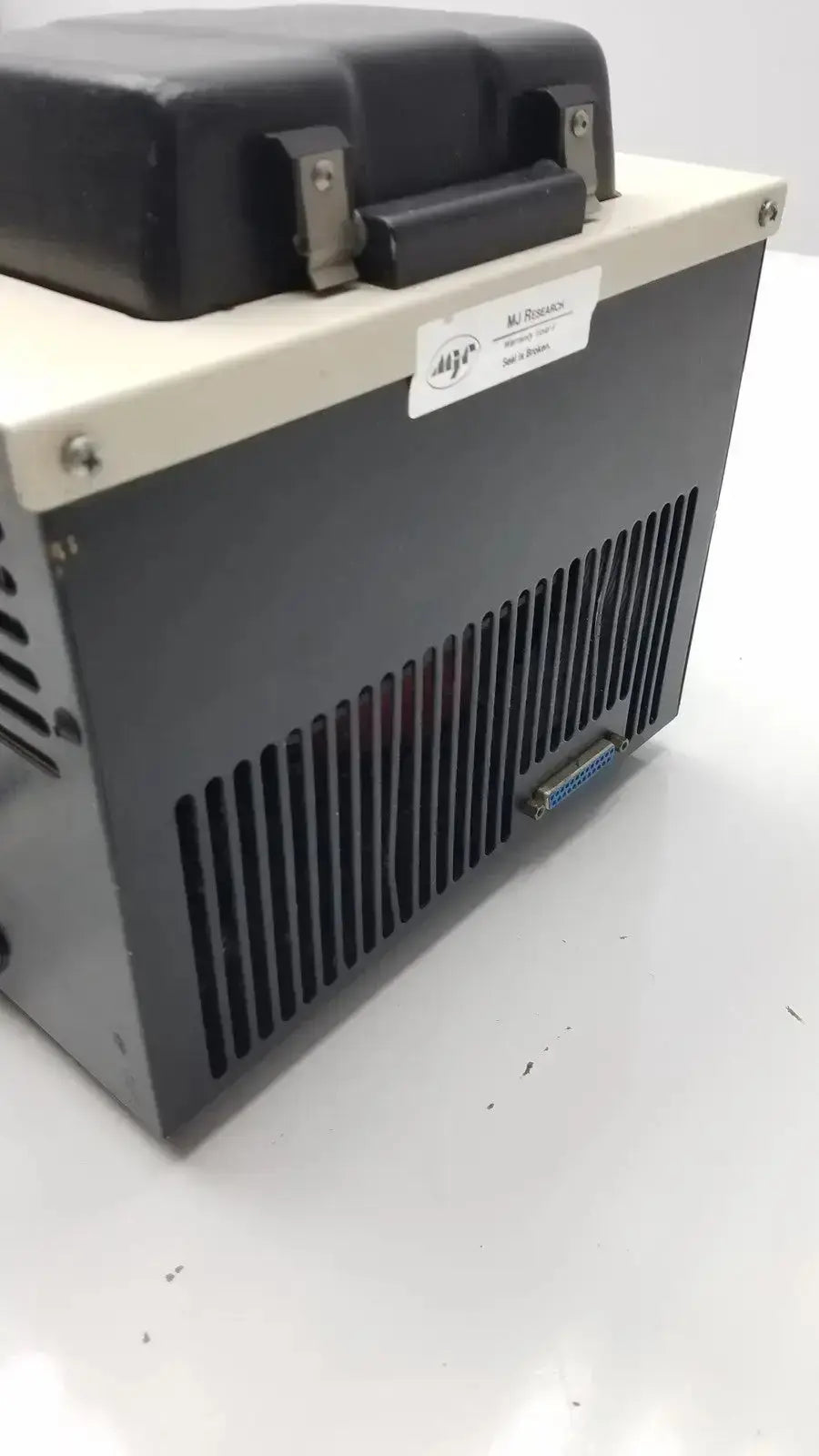 Black and beige industrial-grade programmable thermal controller with vented panel and handle labeled m-1025 model for research ptc-100 programmable use