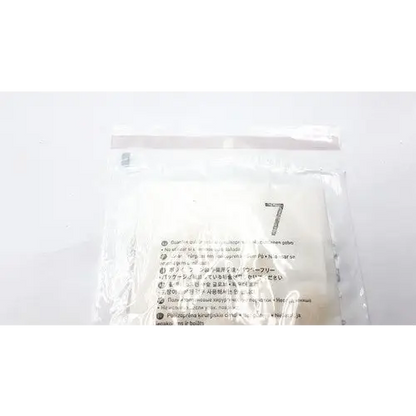 A clear plastic bag containing white, soft-textured filter papers with printed instructions in multiple languages.