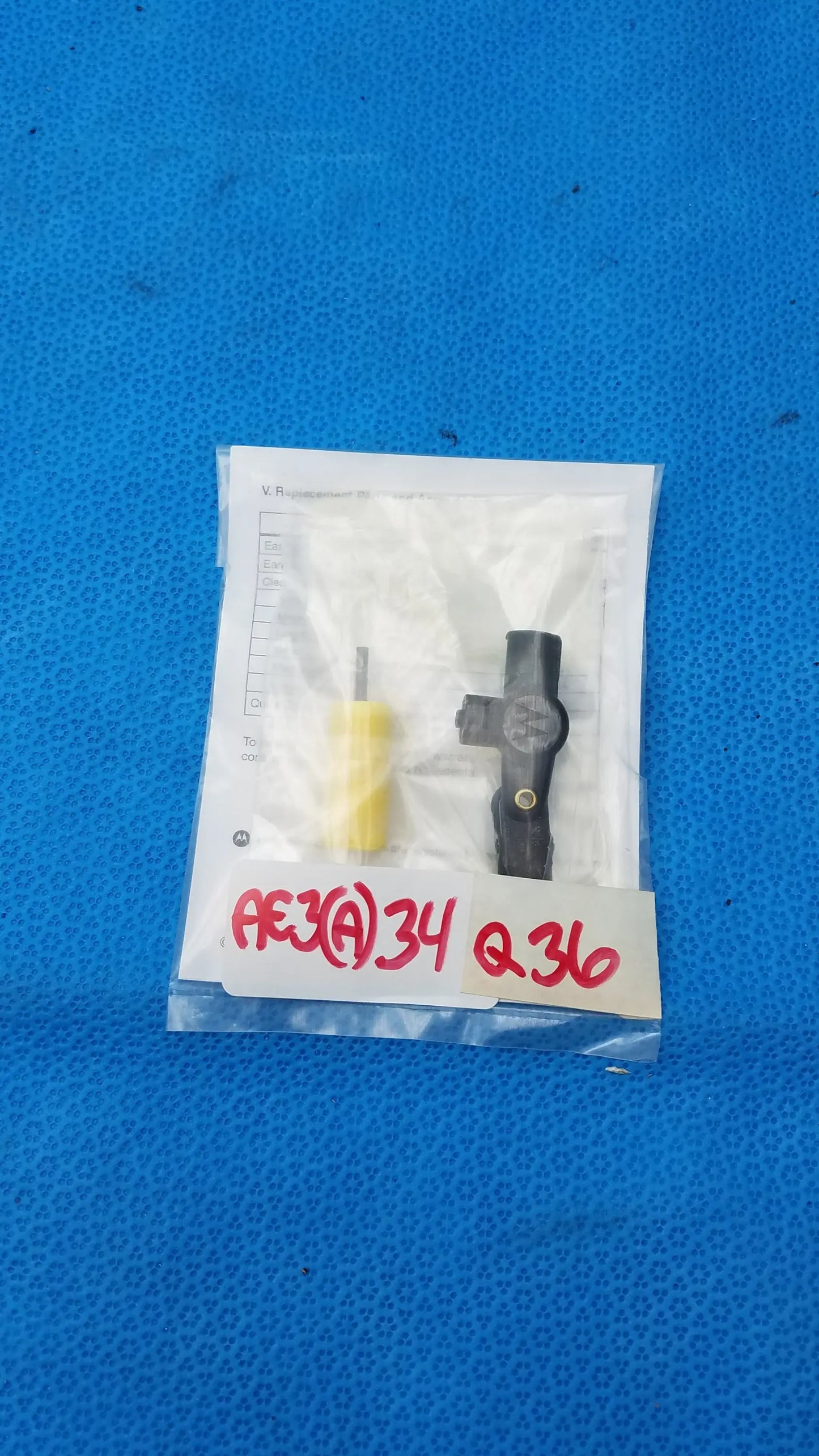Black plastic automotive sensor with yellow handle tool in clear packaging for motorola rln6230a extreme noise kit
