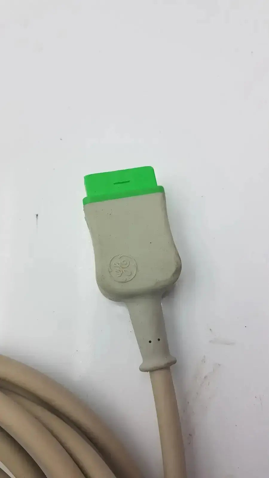 Multi-Link ECG tTrunk cable by GE featuring a beige obd2 diagnostic cable with a bright green connector head