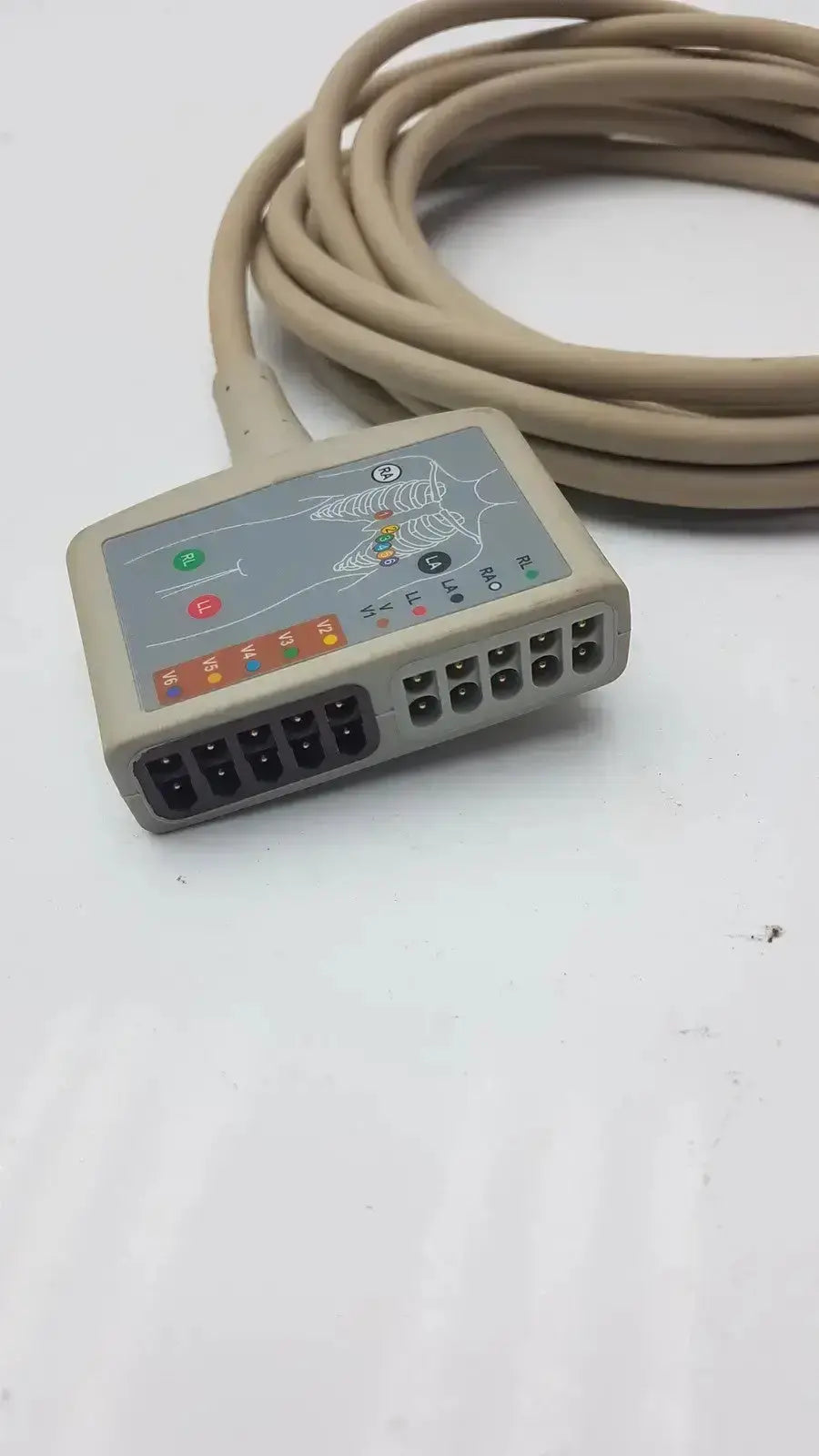 Beige multi-link ecg ttrunk cable by ge with gray control panel and color-coded electrode labels on the back side