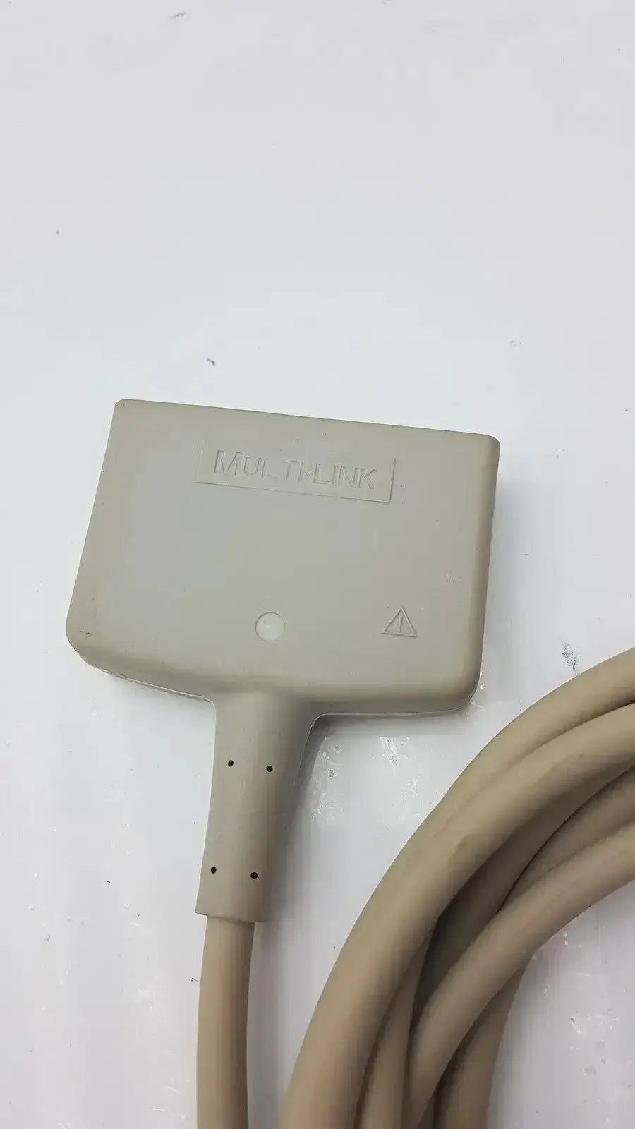 Beige plastic multilink connector with coiled beige cable of GE multi-link ecg ttrunk cable for medical use