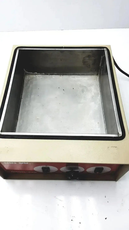 Beige and red napco national appliance company water bath electric hot plate with stainless steel cooking surface