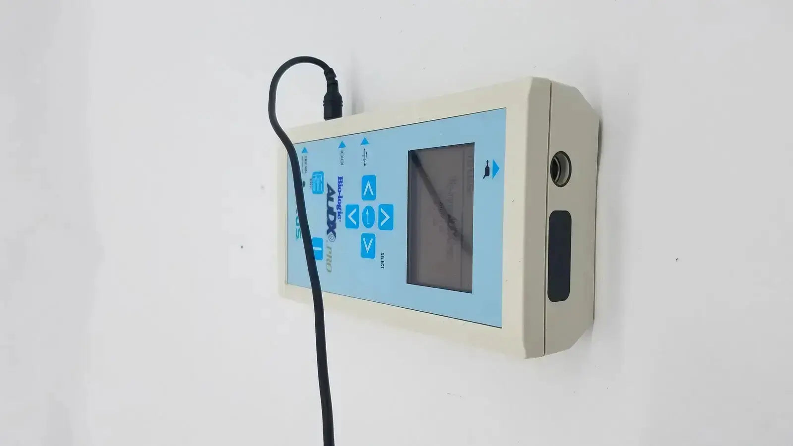 Beige natus bio-logic audx pro medical device with light blue control panel digital screen and black cable for diagnostics