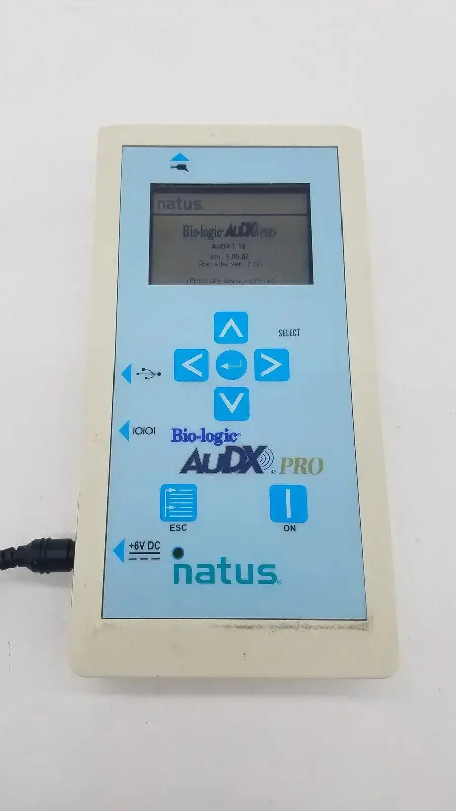 Light beige rectangular natus bio-logic audx pro electronic device with blue-lit display and control buttons for audiology use