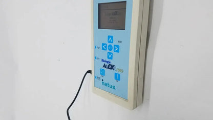 Light blue and beige wall-mounted audio diagnostic device with digital screen and buttons natus bio-logic audx pro