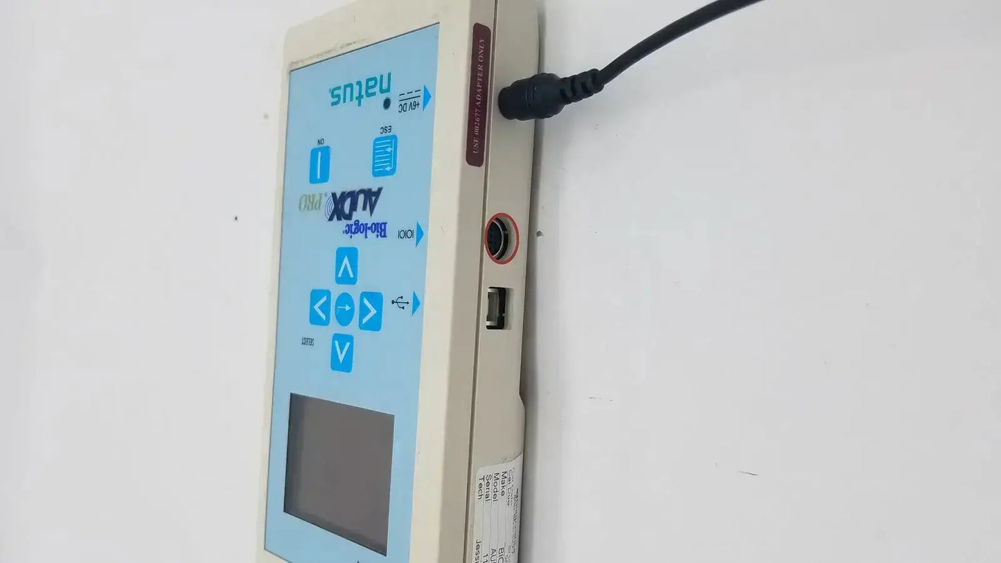 Beige rectangular medical device with blue touchscreen and buttons displaying natus bio-logic audx pro logo