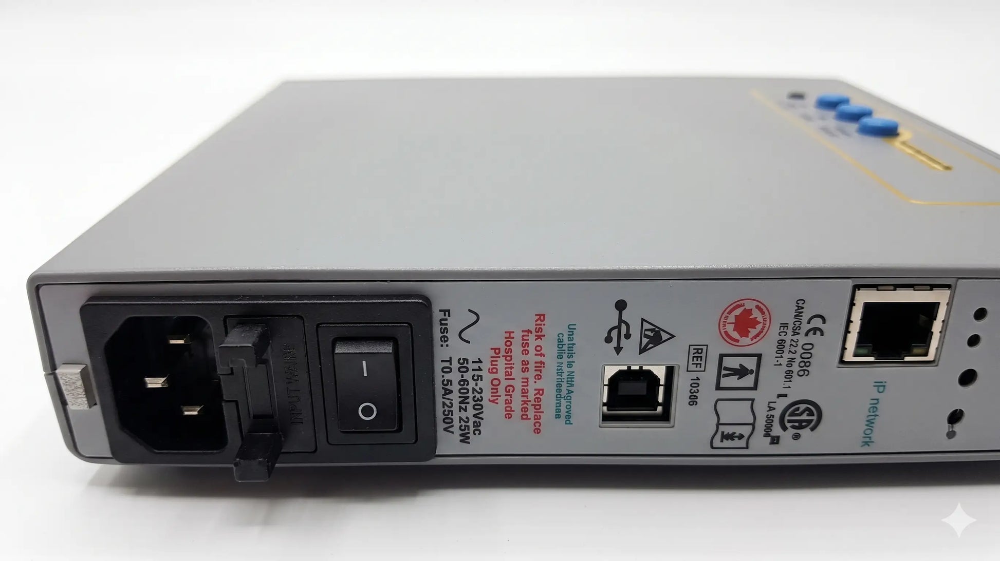 Gray metal network switch with blue indicator lights and ethernet ports on the back of natus neurology xltek brain monitor for reuse medical equipment
