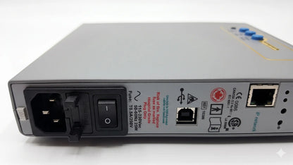 Gray metal network switch with blue indicator lights and ethernet ports on the back of natus neurology xltek brain monitor for reuse medical equipment