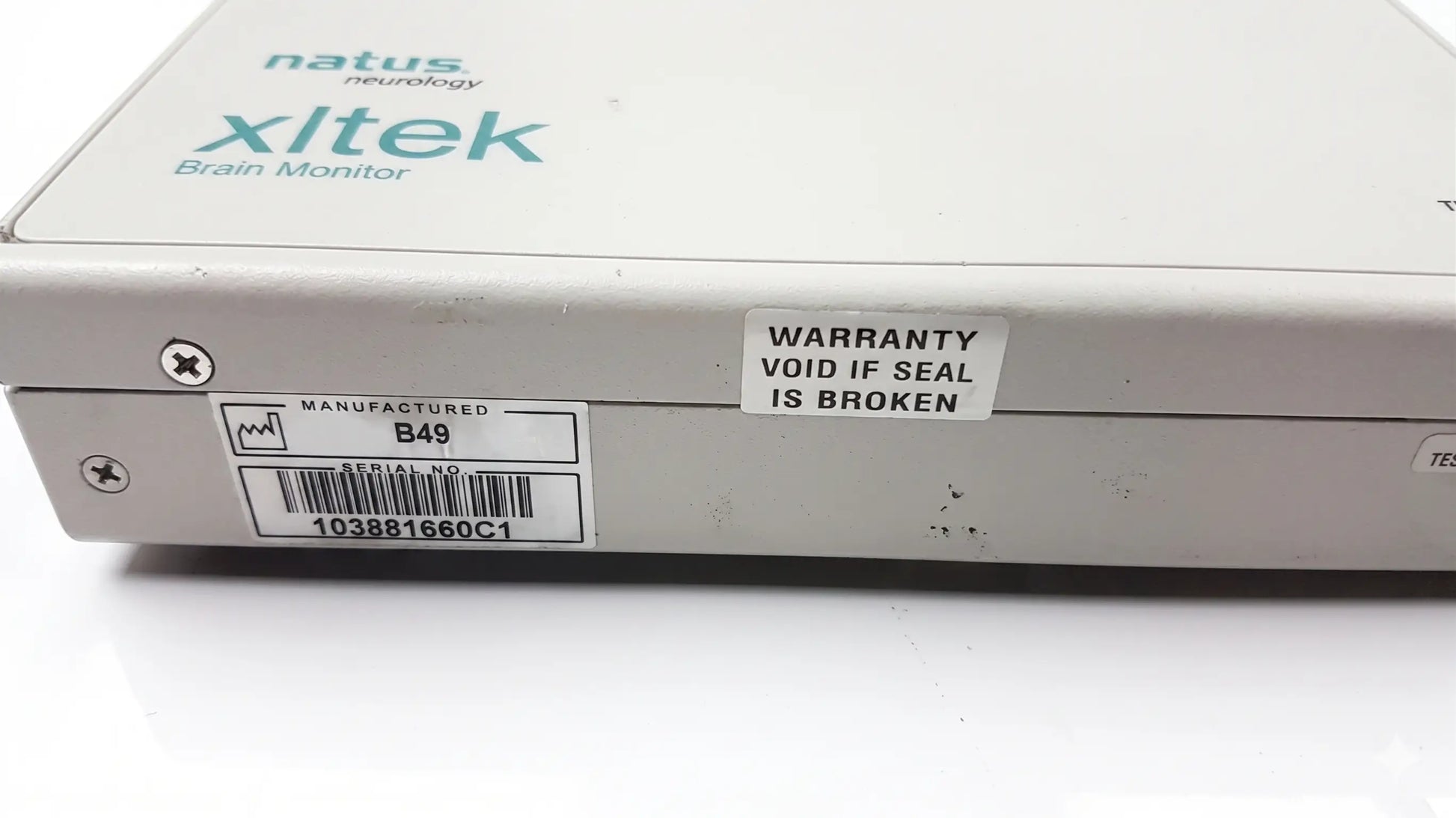 White rectangular brain monitor with natus neurology xltek branding and warranty sticker for reuse medical equipment