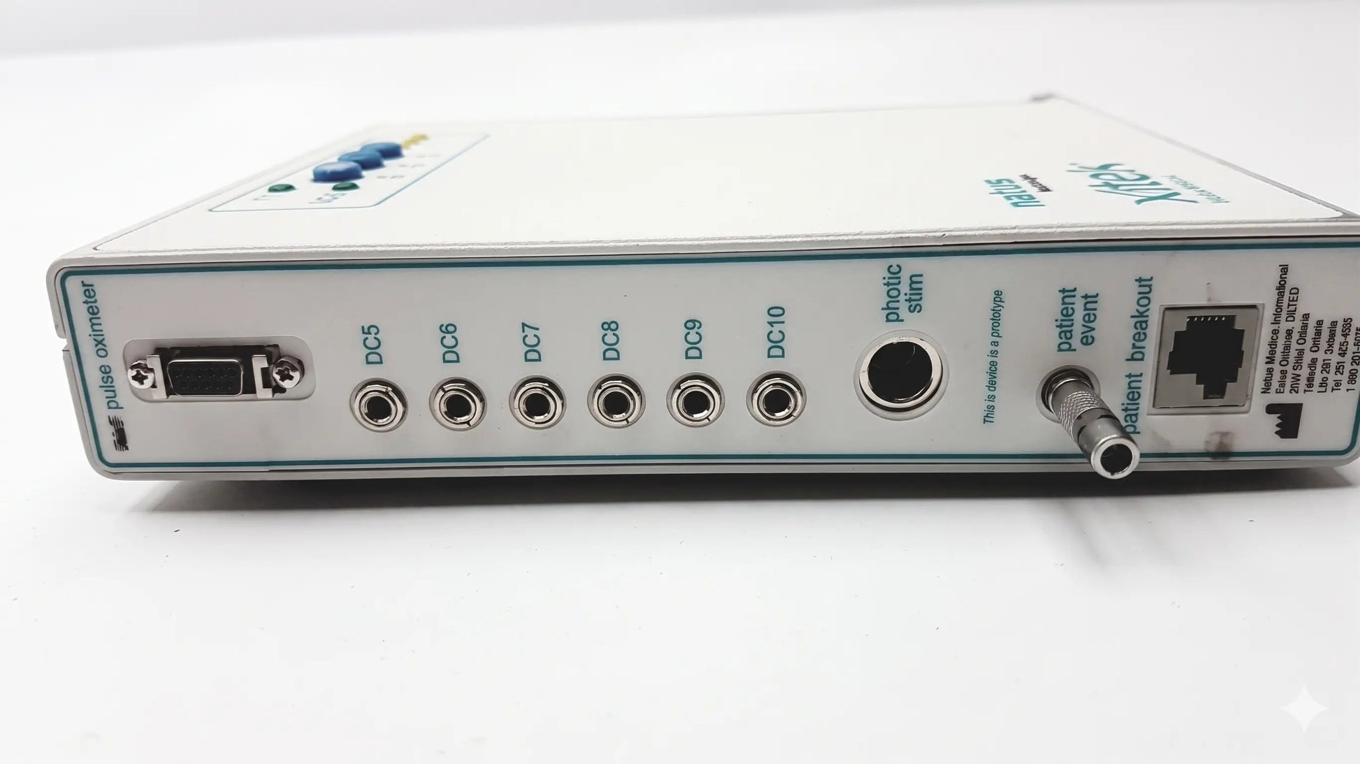 White rectangular brain monitor with multiple ports and a blue button by natus neurology xltek for reuse medical equipment